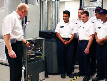 Technicians being trained on a home furnace system.